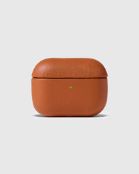 Cognac genuine leather AirPods case closed with the green status light visible