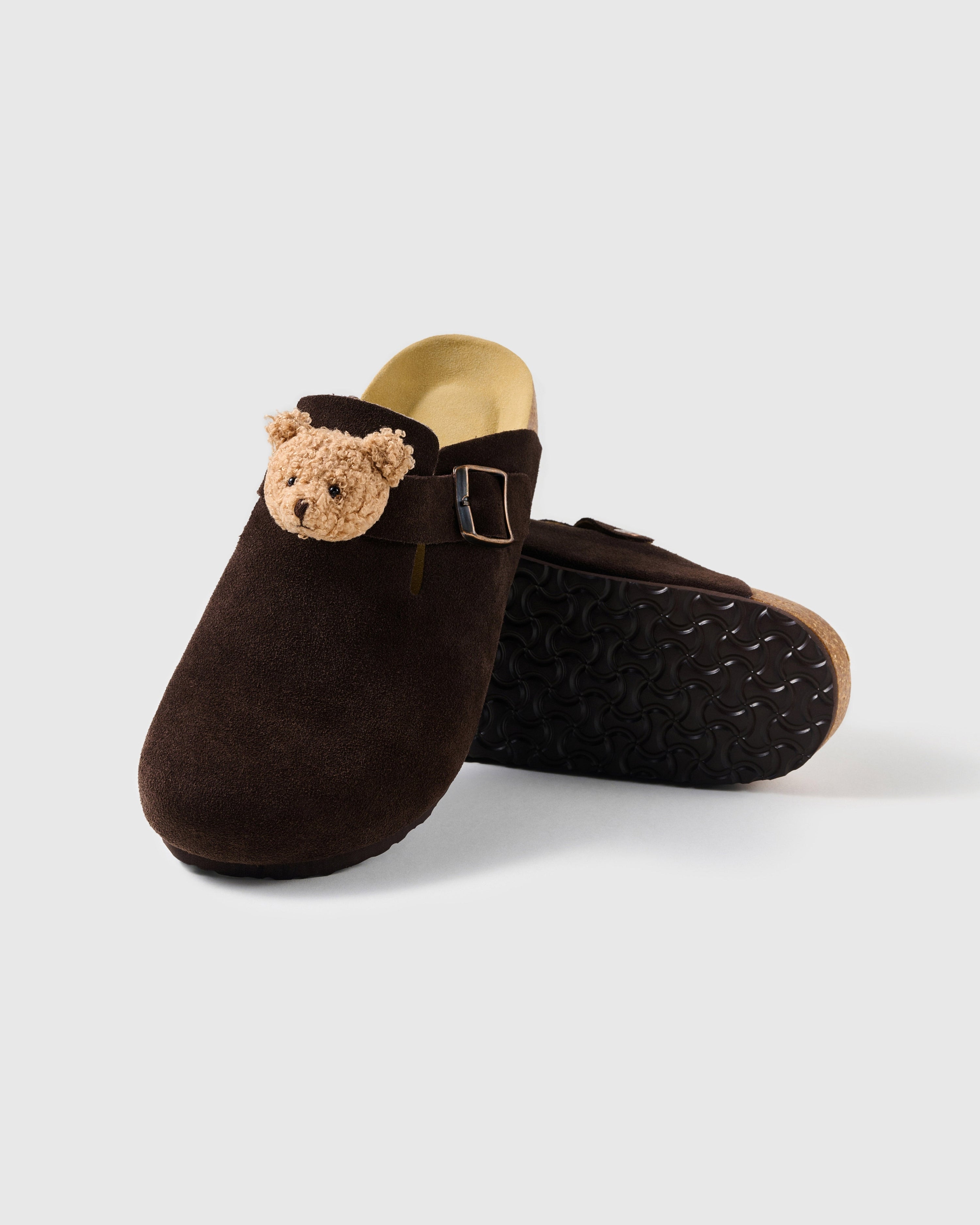 STICKYZOO chocolate-brown suede clogs with a light tan plush teddy bear face, closed toe, and adjustable buckle strap