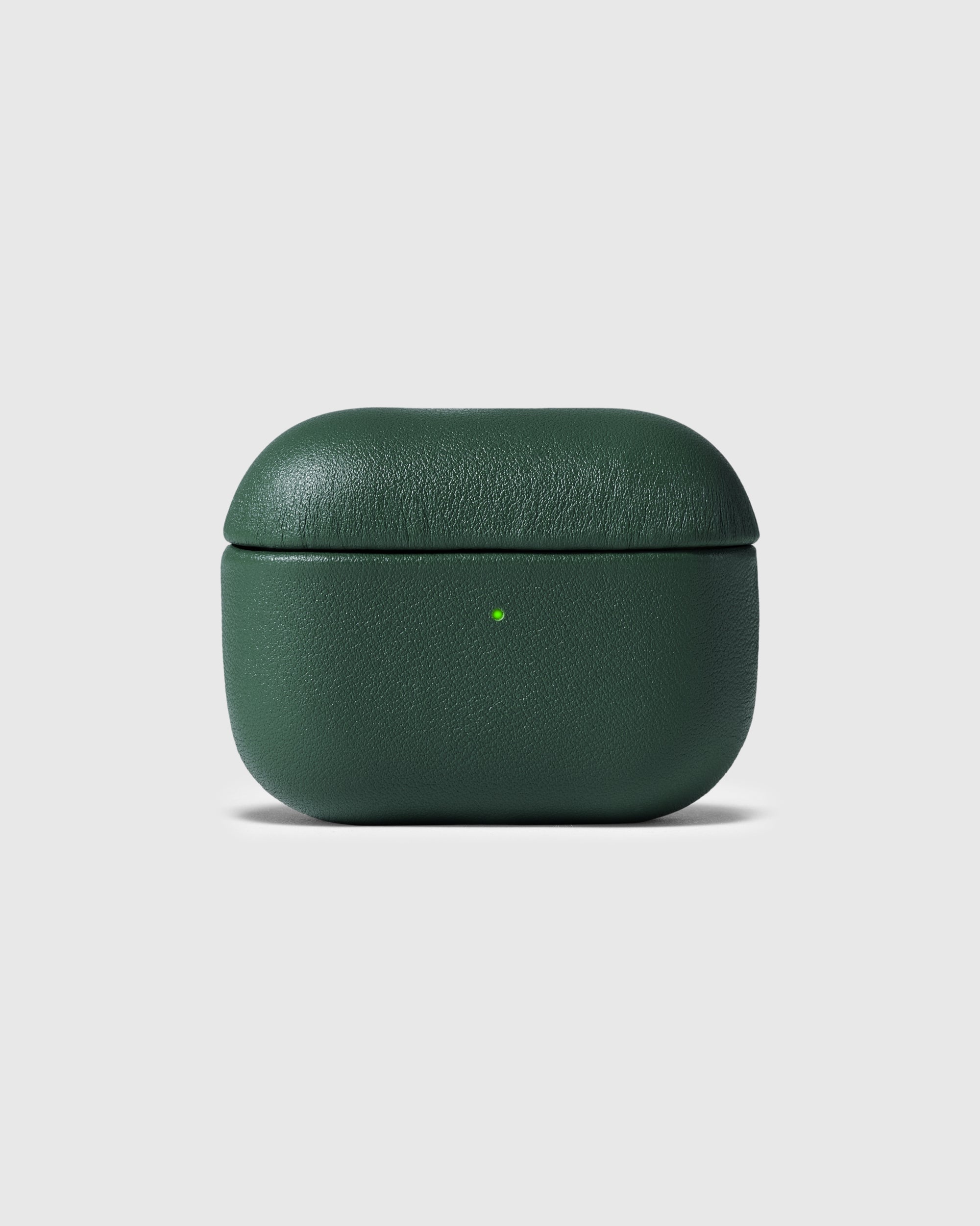 Green genuine leather AirPods case closed with the green status light visible
