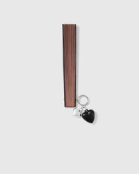 Closed chestnut STICKYZOO all-bamboo hand fan with double-heart charm
