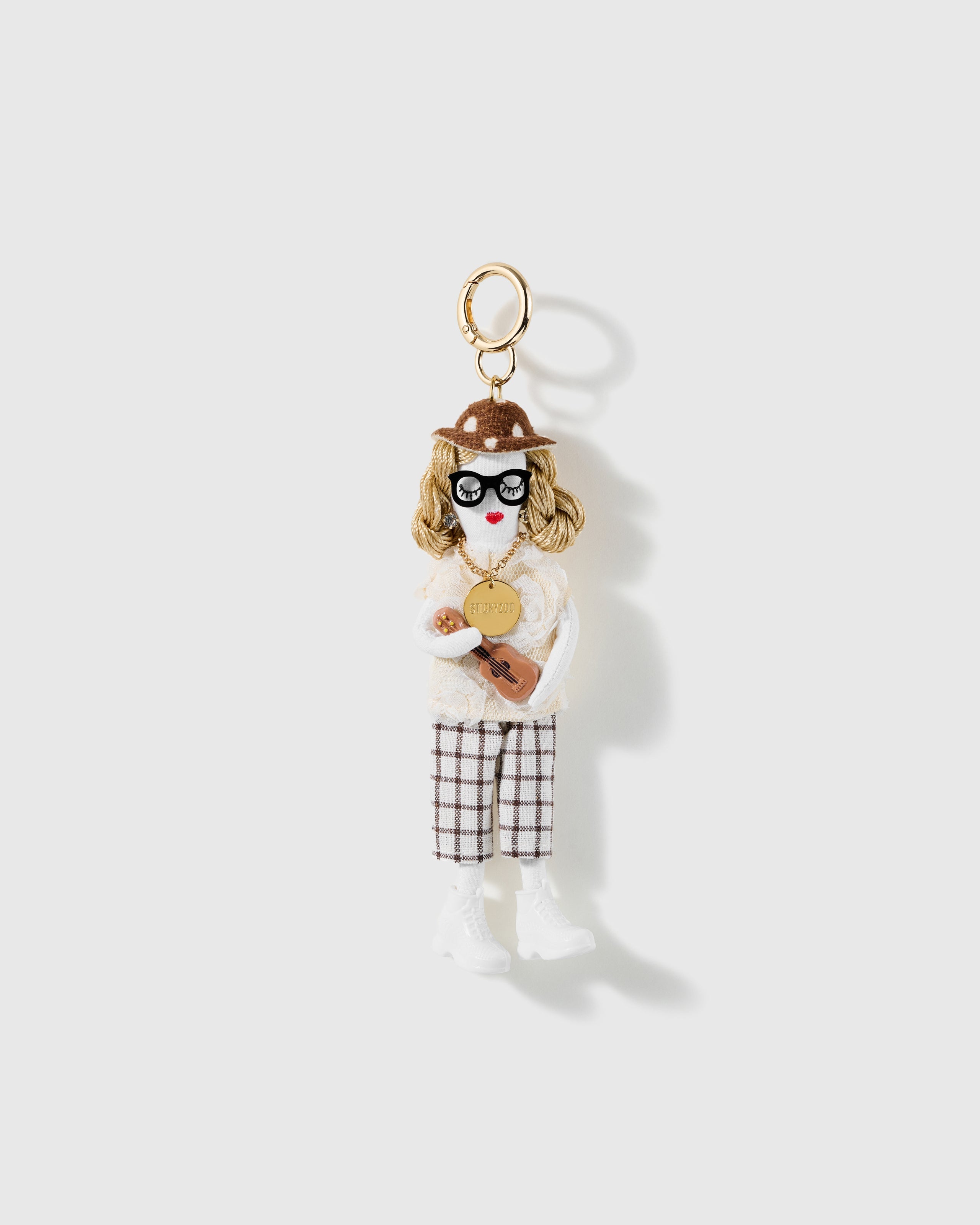 Sunday Guitar Charm, textile character with spotted hat, cream lace top, check trousers and miniature guitar, on a light background