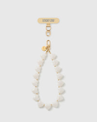 STICKYZOO Coconut Heart phone strap: full strand of milky white heart beads with gold-tone spacers, gold hook and engraved disc, shown on white.