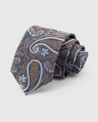 STICKYZOO Midnight Chestnut Paisley Tie rolled on white, showing large paisley scrolls across 100% mulberry silk in midnight navy with chestnut, pale-blue and cocoa accents