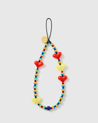 Rainbow Heart phone strap laid flat: rainbow-striped beads, glossy red and yellow hearts, a deep-blue bead, black cord loop and gold STICKYZOO disc.