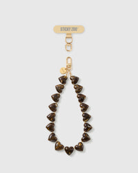 STICKYZOO Tortoiseshell Heart phone strap: full strand of amber-and-cocoa marbled heart beads with gold-tone hook, engraved disc and strap card.