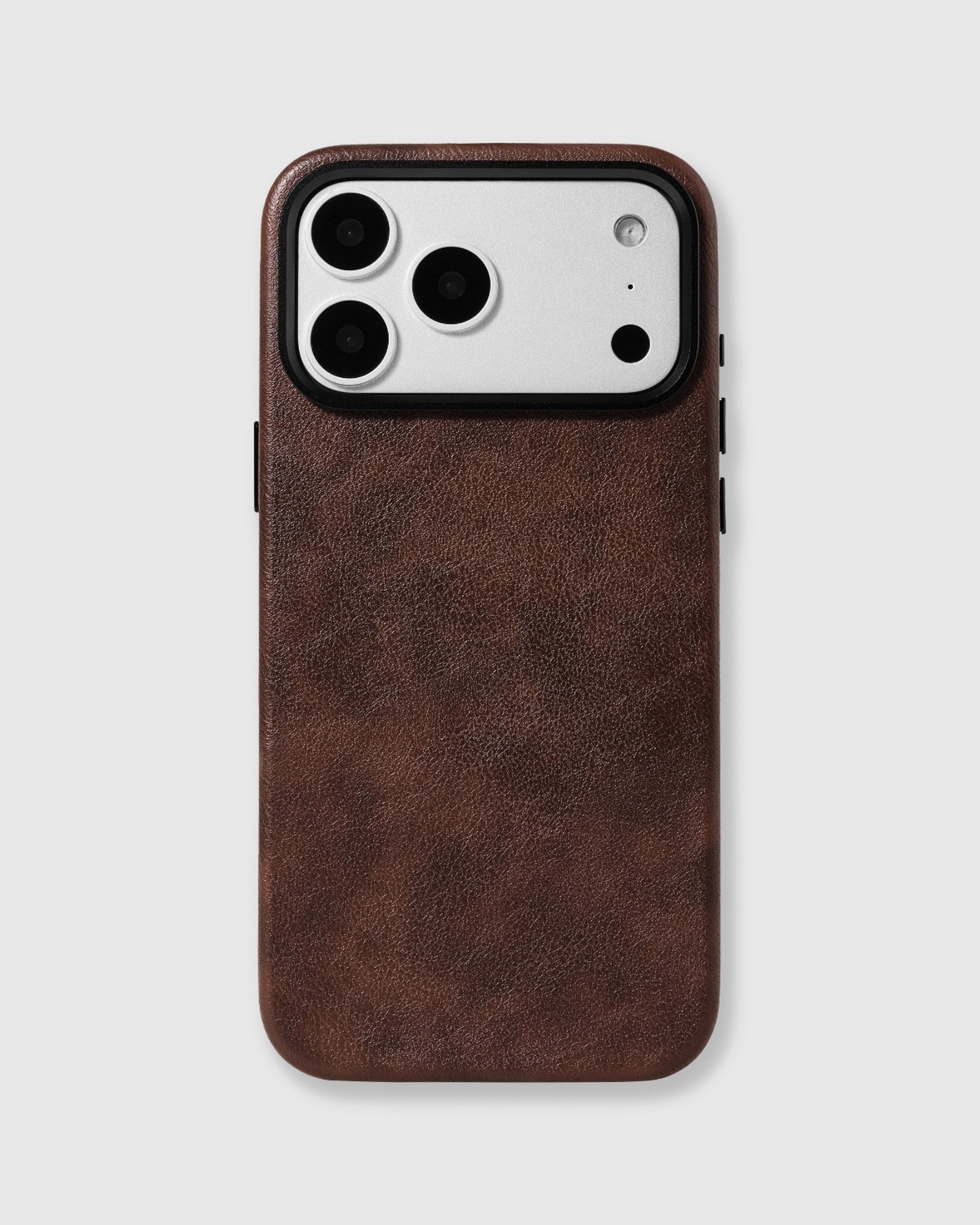 Brown Heritage Leather Case with a deep warm brown textured vegan leather surface and raised metal camera edge