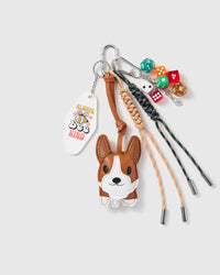 Corgi Lucky Dice Stack Charm with a corgi face, multicolour dice, positive-message tag and green-and-orange cords on a light background