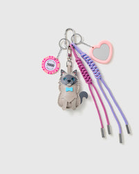 Lucky Cat Heart Stack Charm with a grey cat, heart outline, lucky chip motif and lilac braided cords on a light background