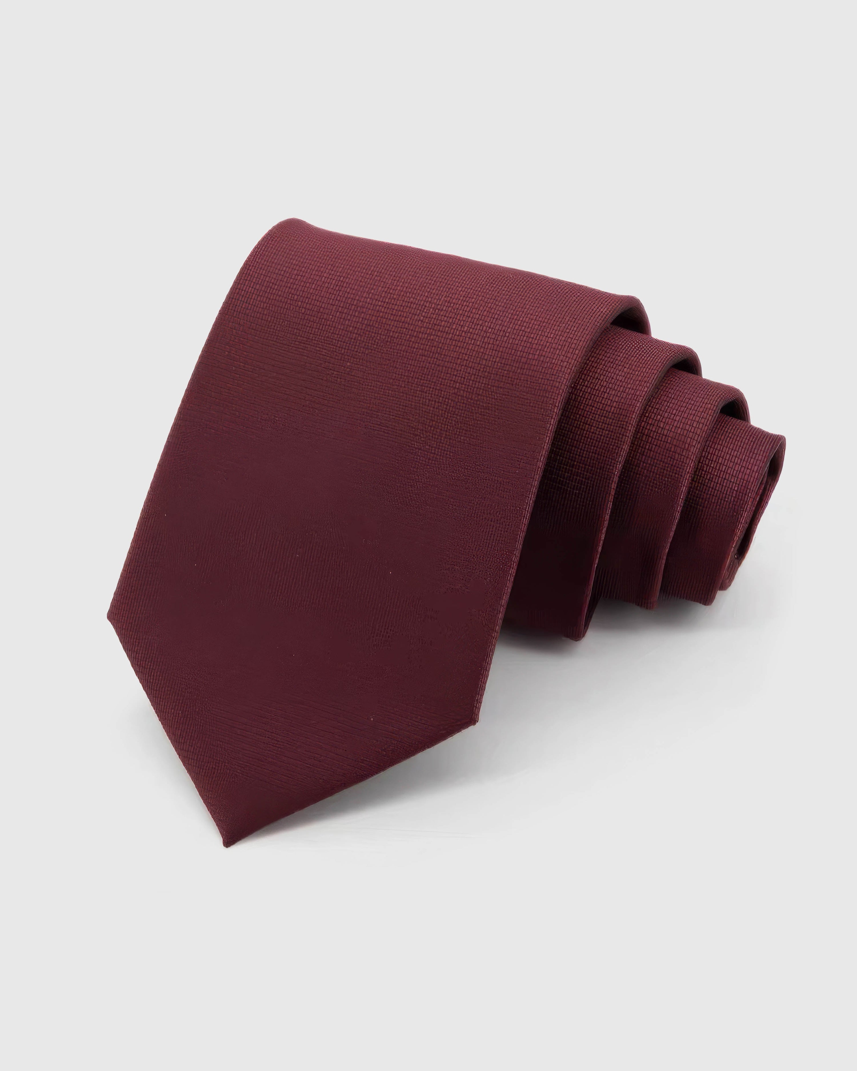 STICKYZOO Claret Texture Tie in claret silk, rolled to show claret tonal silk texture across the blade.