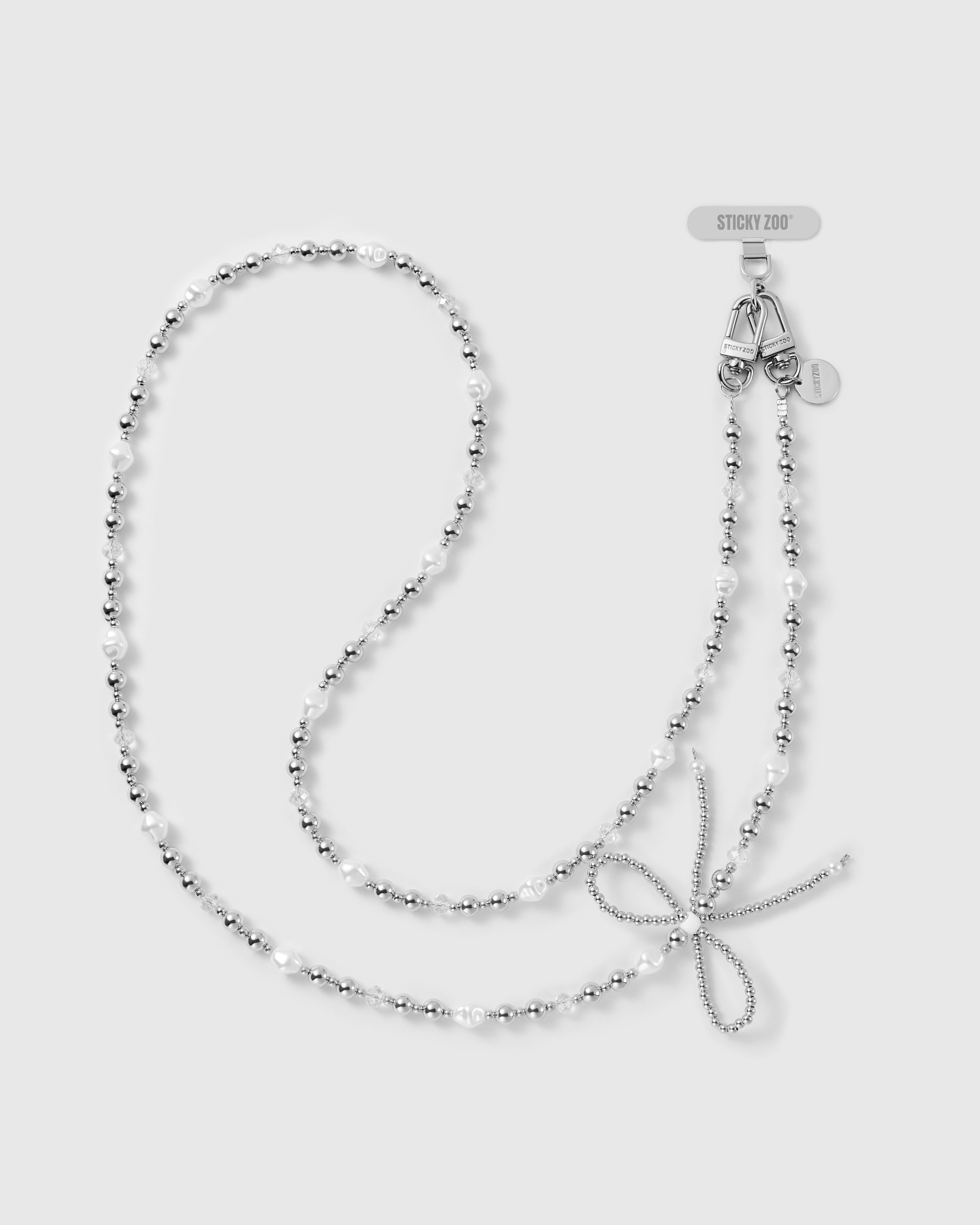 STICKYZOO cross-body phone strap with silver-tone balls, white keshi faux-pearls, clear faceted beads, a woven bow and dual clasps.