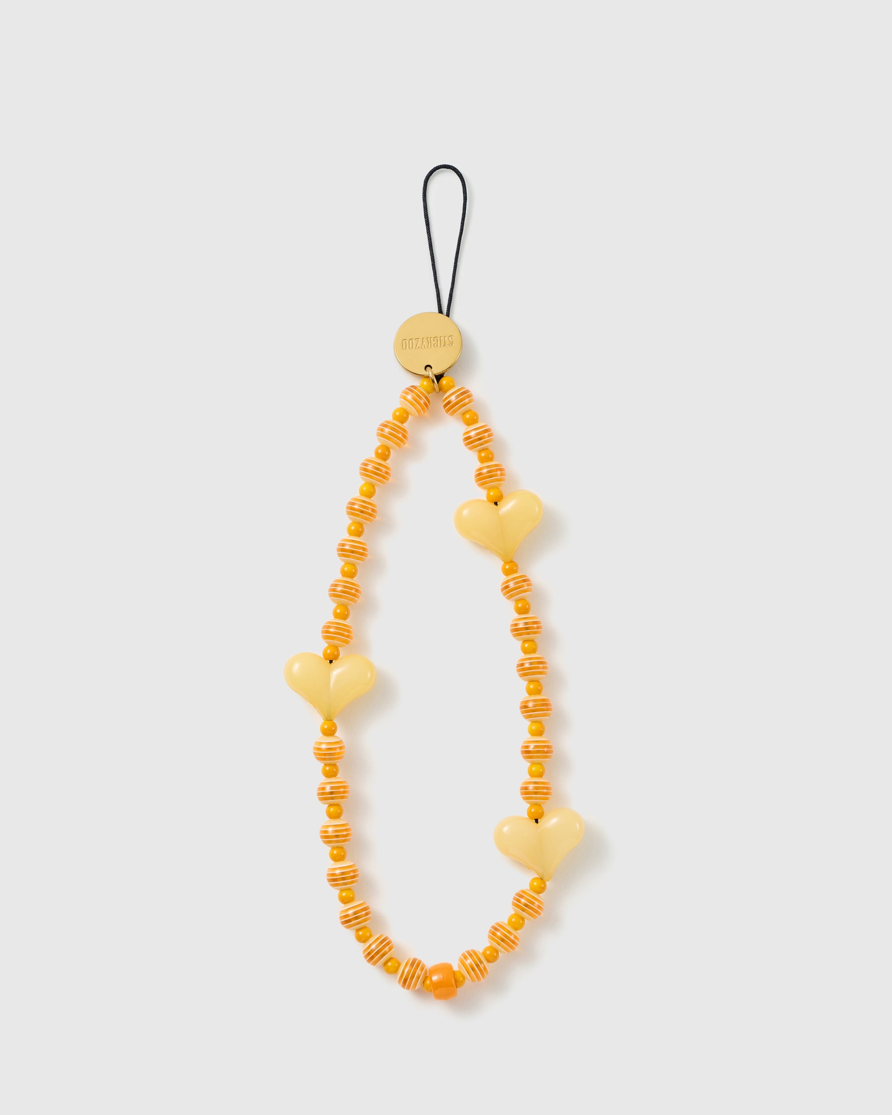 STICKYZOO Apricot Heart phone strap with glossy yellow hearts, orange-and-cream striped beads, marigold accents and a black cord loop.