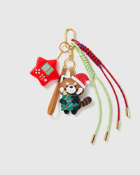 Holiday Red Panda Game Stack Charm with a holiday red-panda character, red game motif, stitched tag and multicolour cords on a light background