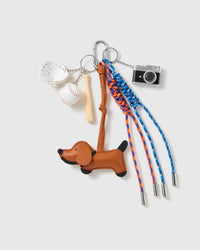 Dachshund Baseball Stack Charm with a brown dachshund, baseball motifs, miniature camera and blue-and-orange cords on a light background