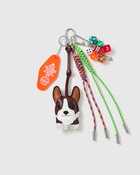 Boston Terrier Dice Stack Charm with a boston-terrier face, multicolour dice, stitched tag and green-and-orange cords on a light background