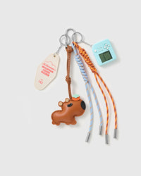 Dachshund Arcade Message Stack Charm with a brown dachshund, blue handheld-game motif, message tag and blue-and-orange cords on a light background