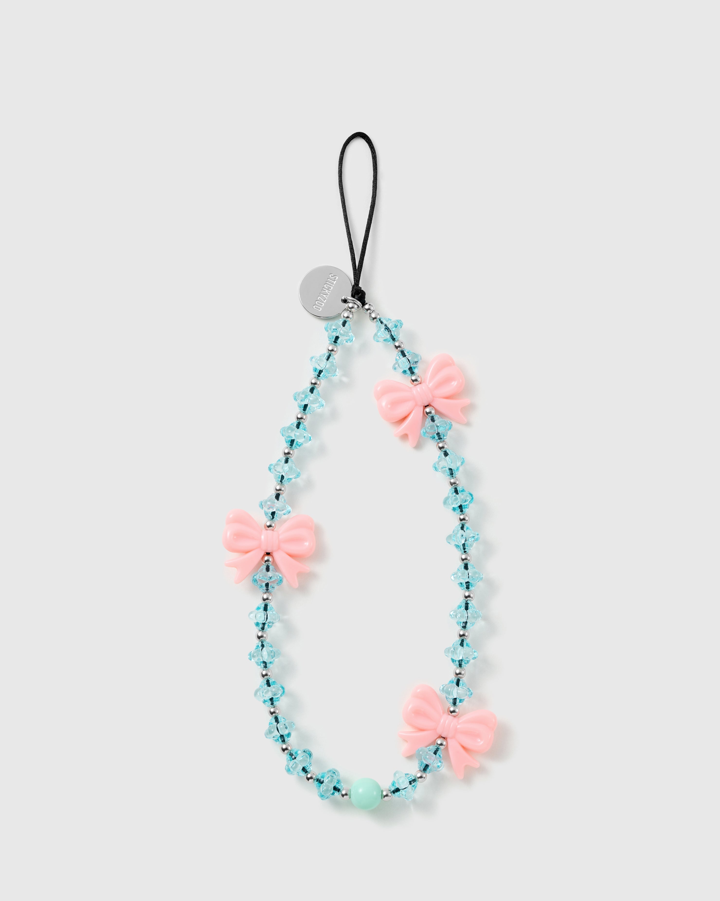 STICKYZOO Frost Bow phone strap laid flat: three glossy pink bows on faceted ice-blue beads with silver-tone rounds and one mint bead, black cord loop