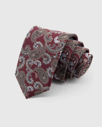STICKYZOO Claret Paisley Tie rolled on white, showing large paisley florals across 100% mulberry silk in claret red