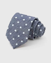 STICKYZOO Slate Daisy Tie rolled on white, showing small daisy blossoms across 100% mulberry silk in slate grey