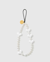 STICKYZOO Snow Heart phone strap with glossy white puffy hearts, ribbed cream-white disc beads, a gold-tone disc and black cord loop.