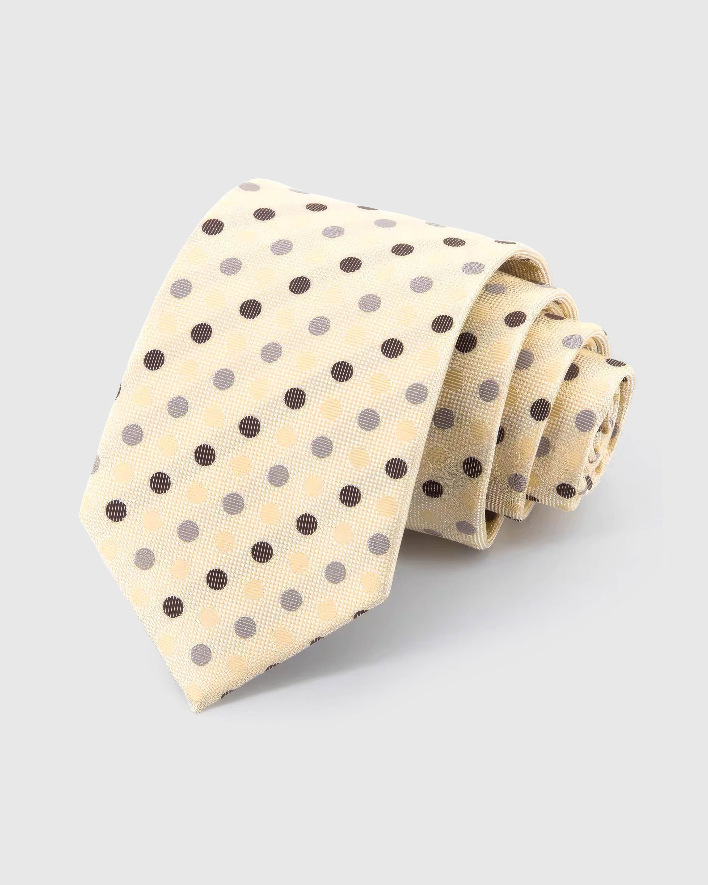 STICKYZOO Ivory Tricolor Dot Tie rolled on white, showing espresso, pewter and cream polka dots across 100% mulberry silk in ivory cream