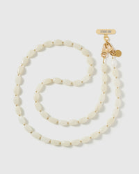 Full-length STICKYZOO cross-body phone strap strung with high-gloss cream resin nugget beads with a soft translucent glow