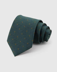 STICKYZOO Forest Micro Tile Tie rolled on white, showing micro open tiles and dots across 100% mulberry silk in forest green