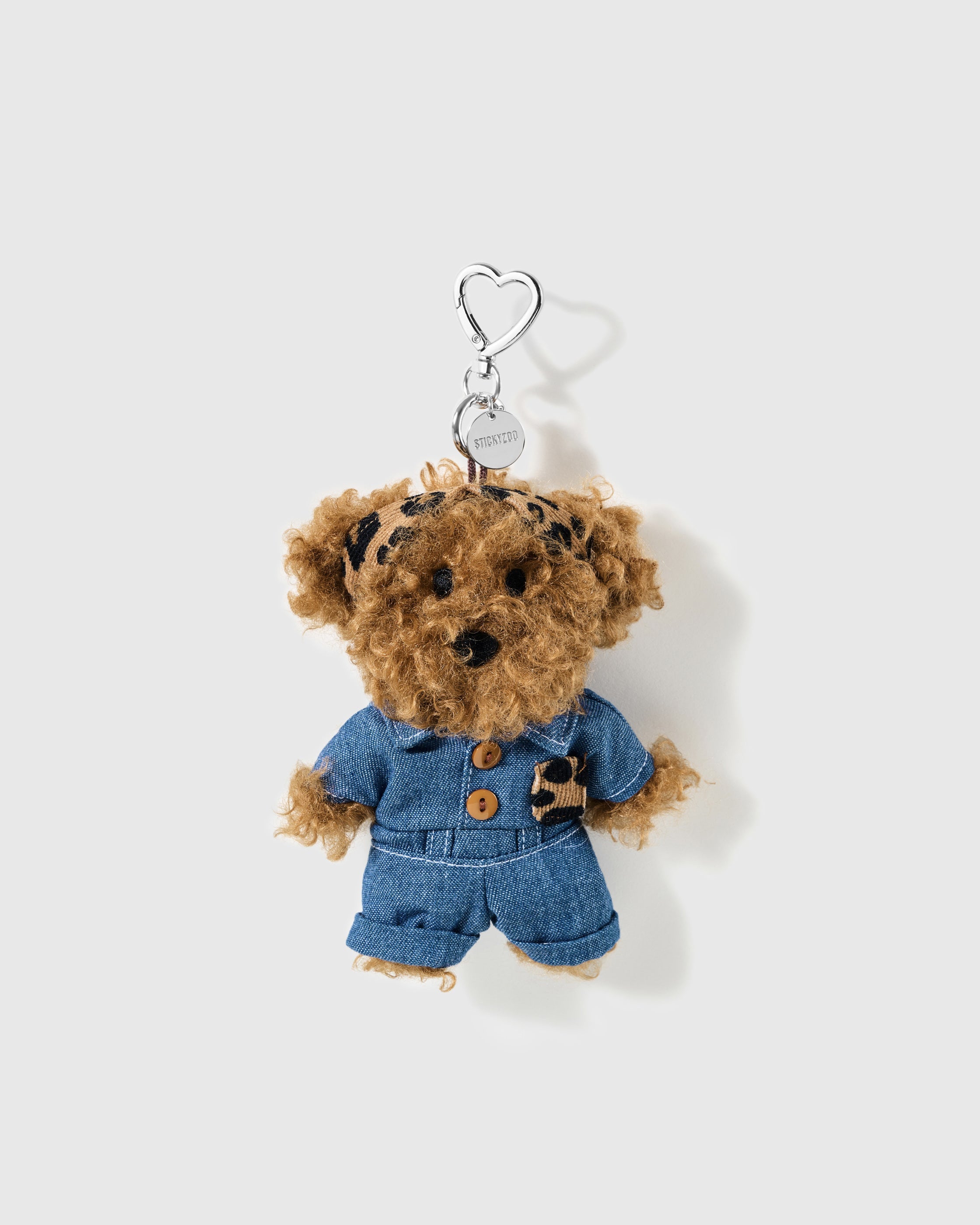 Brown curly poodle charm wearing a leopard headband and denim-look outfit with a silver-colour heart clip