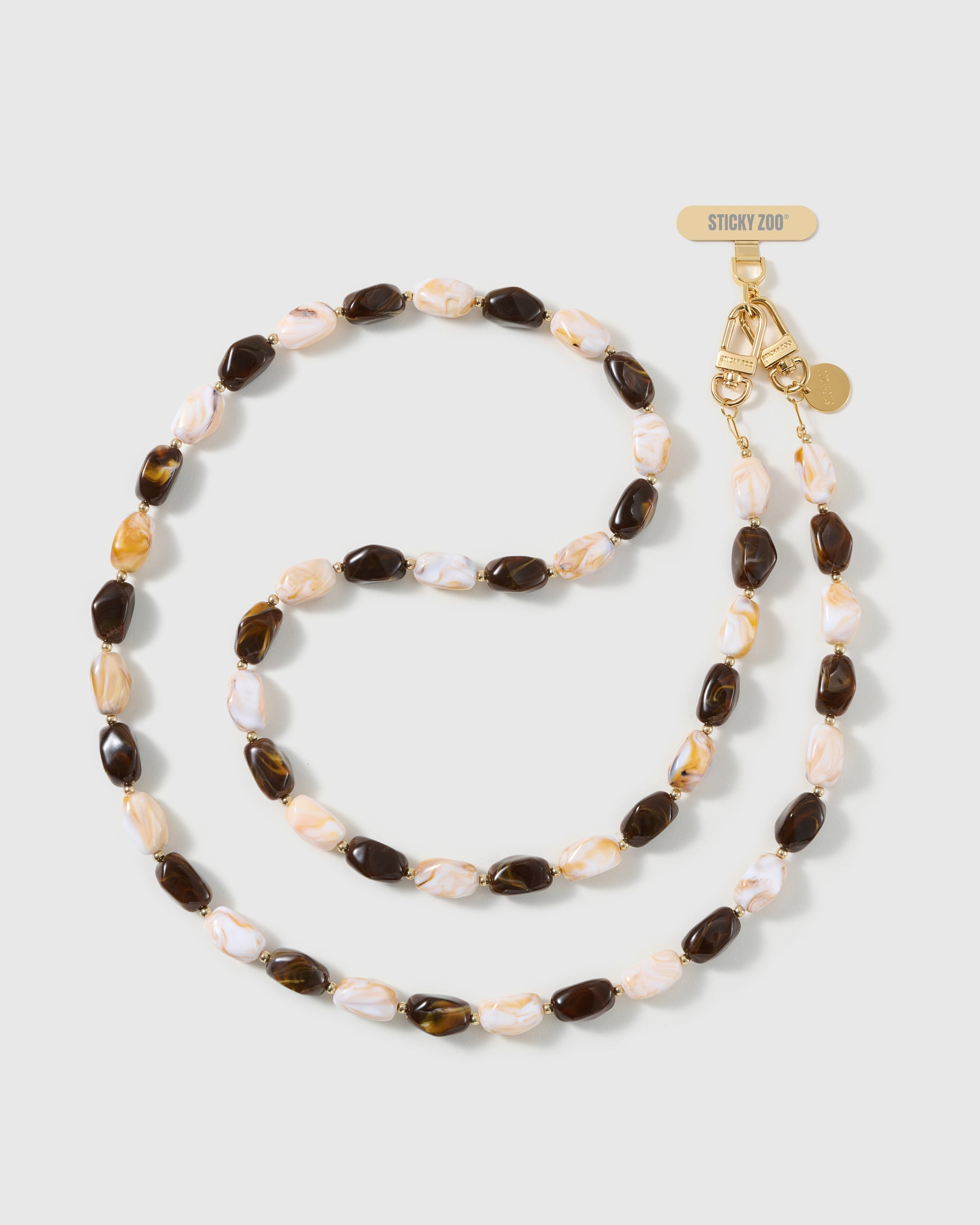 Full-length STICKYZOO cross-body phone strap strung with high-gloss resin nugget beads in tortoiseshell brown and cream