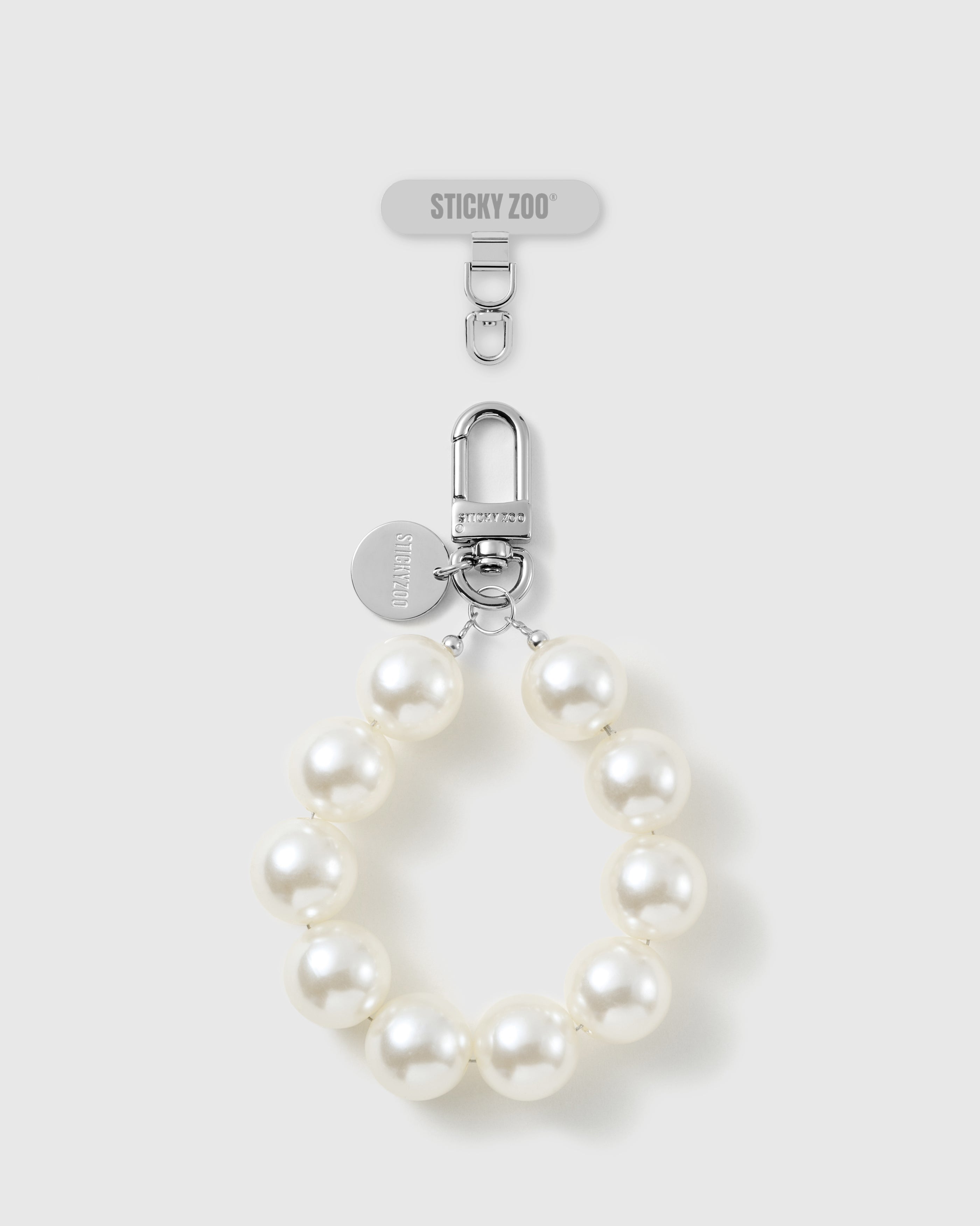 Handmade white pearl-style beaded phone strap by STICKYZOO with silver-tone engraved hardware