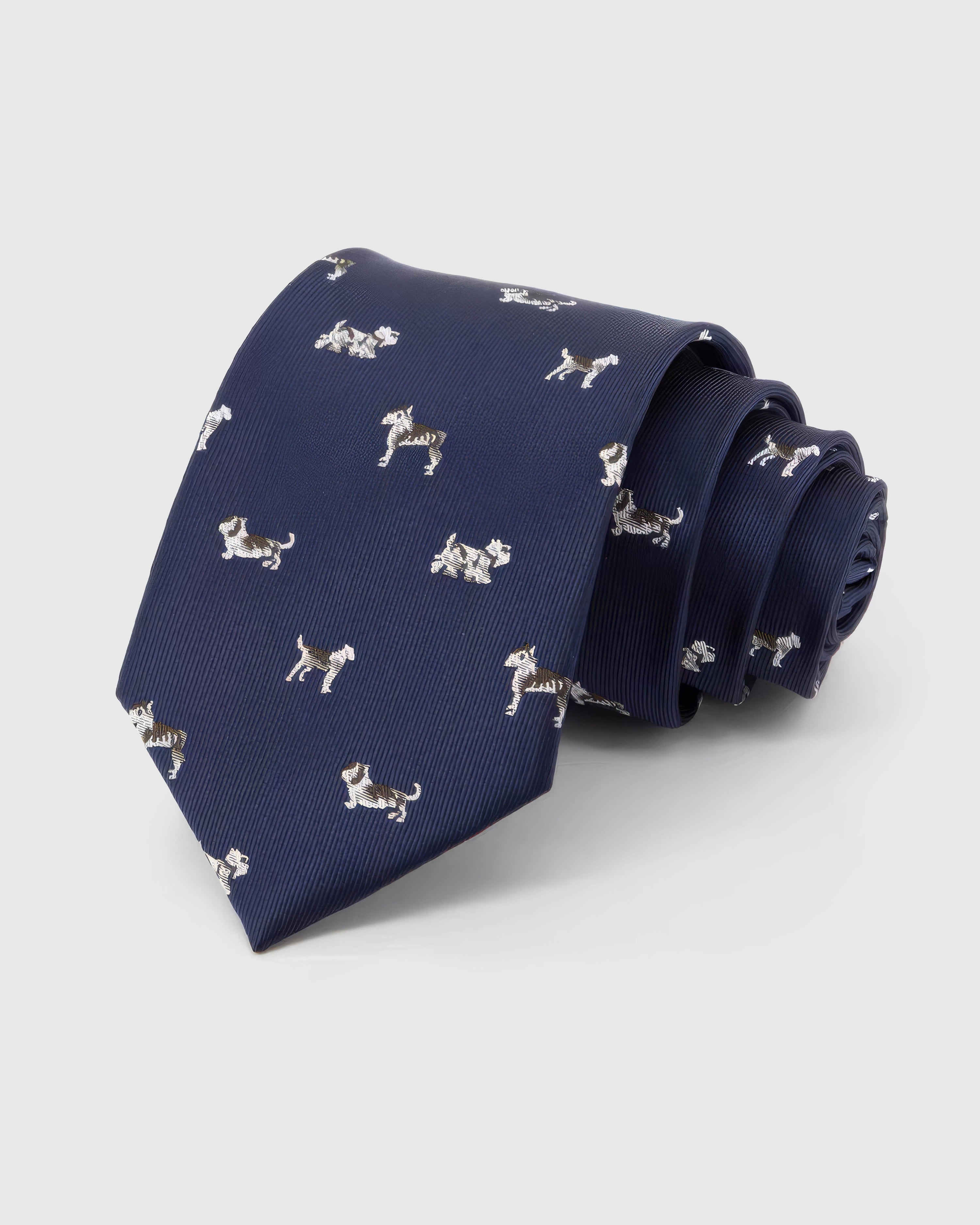 STICKYZOO Midnight Dog Parade Tie in midnight navy silk, rolled to show midnight ground with ivory, taupe and chestnut dog silhouettes across the blade.