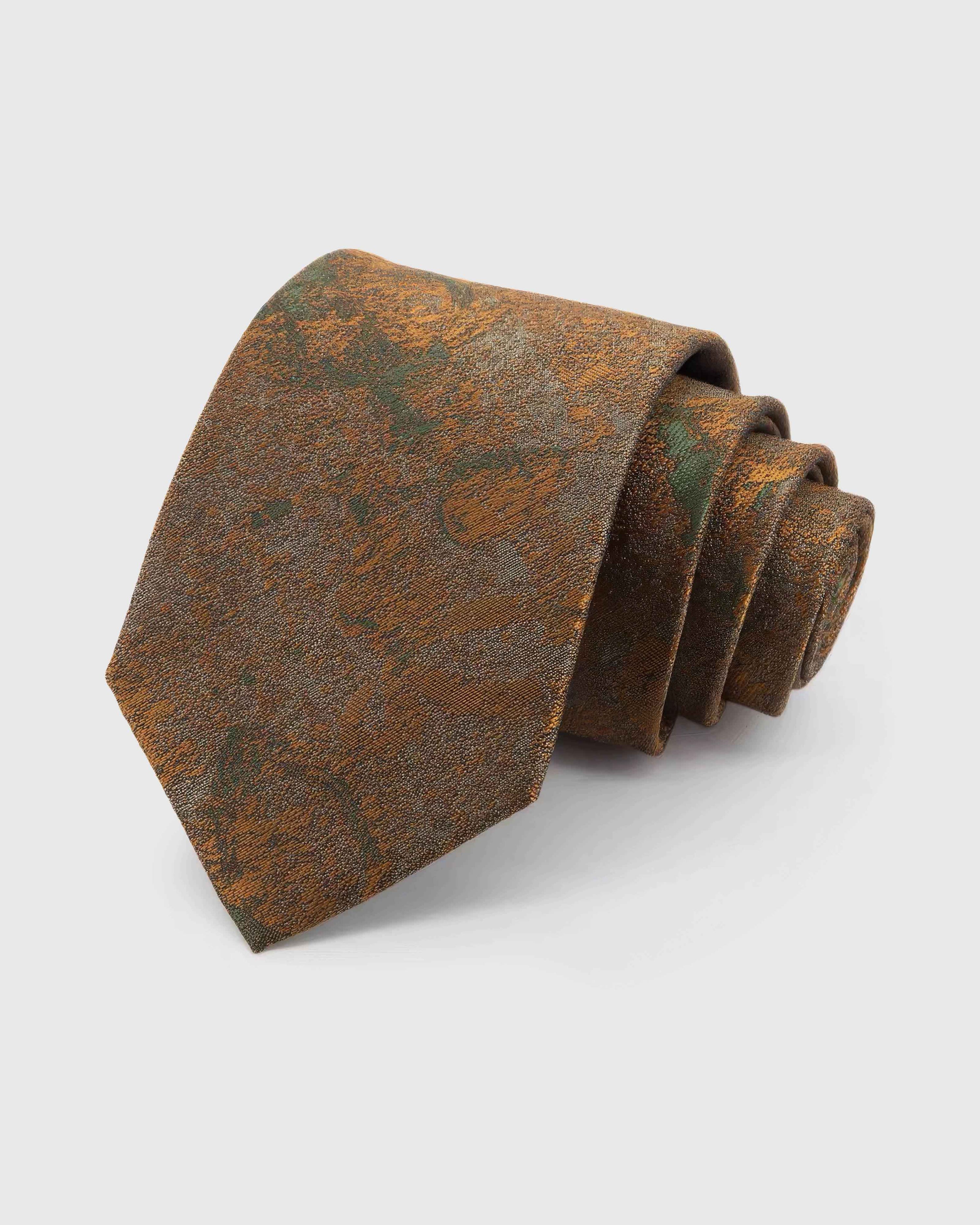 STICKYZOO Umber Patina Tie in umber and bronze silk, rolled to show umber and bronze patina with moss and amber forms across the blade.