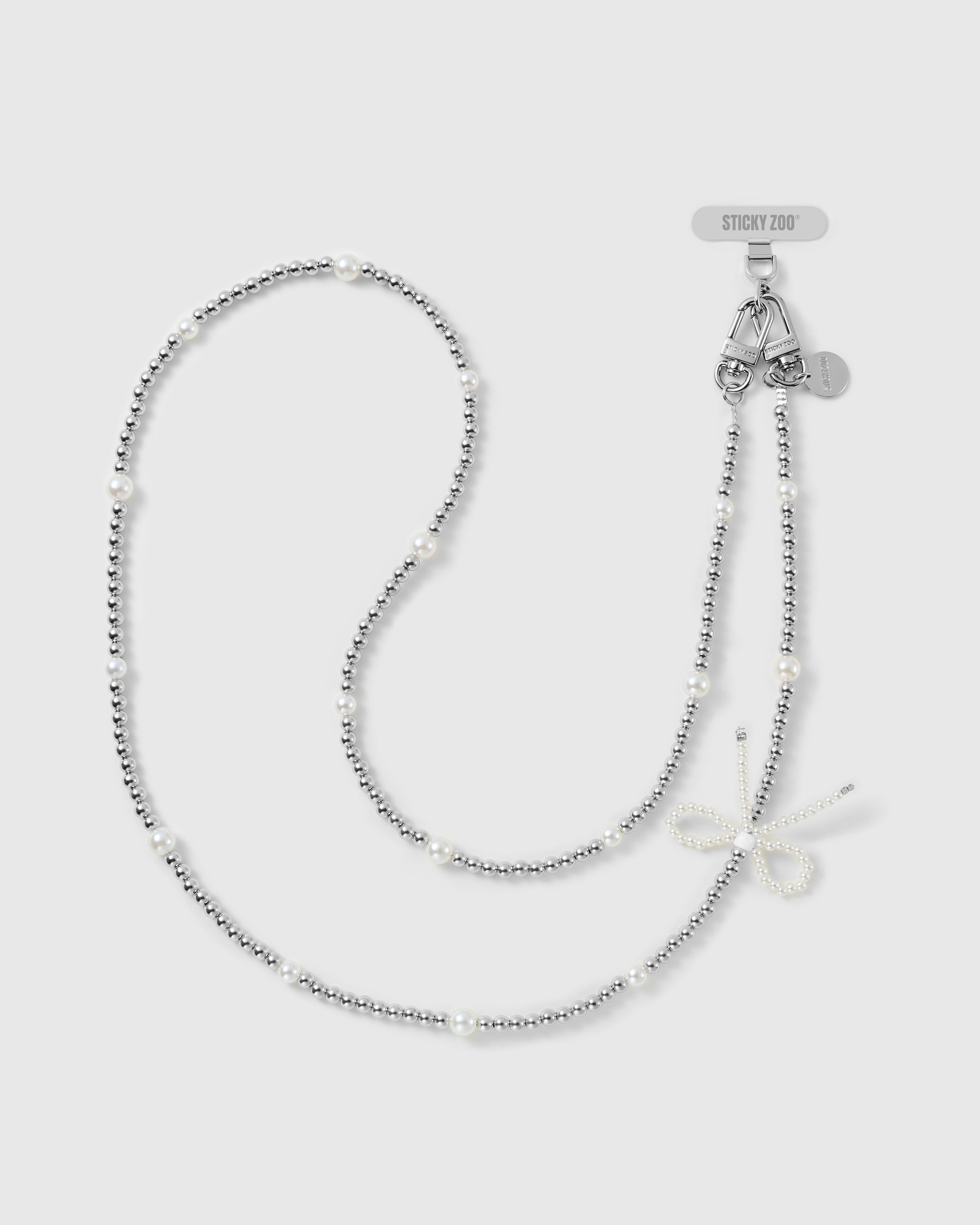 STICKYZOO silver-tone cross-body phone strap with ball beads, rounded faux-pearls, a faux-pearl bow, dual clasps and engraved disc.