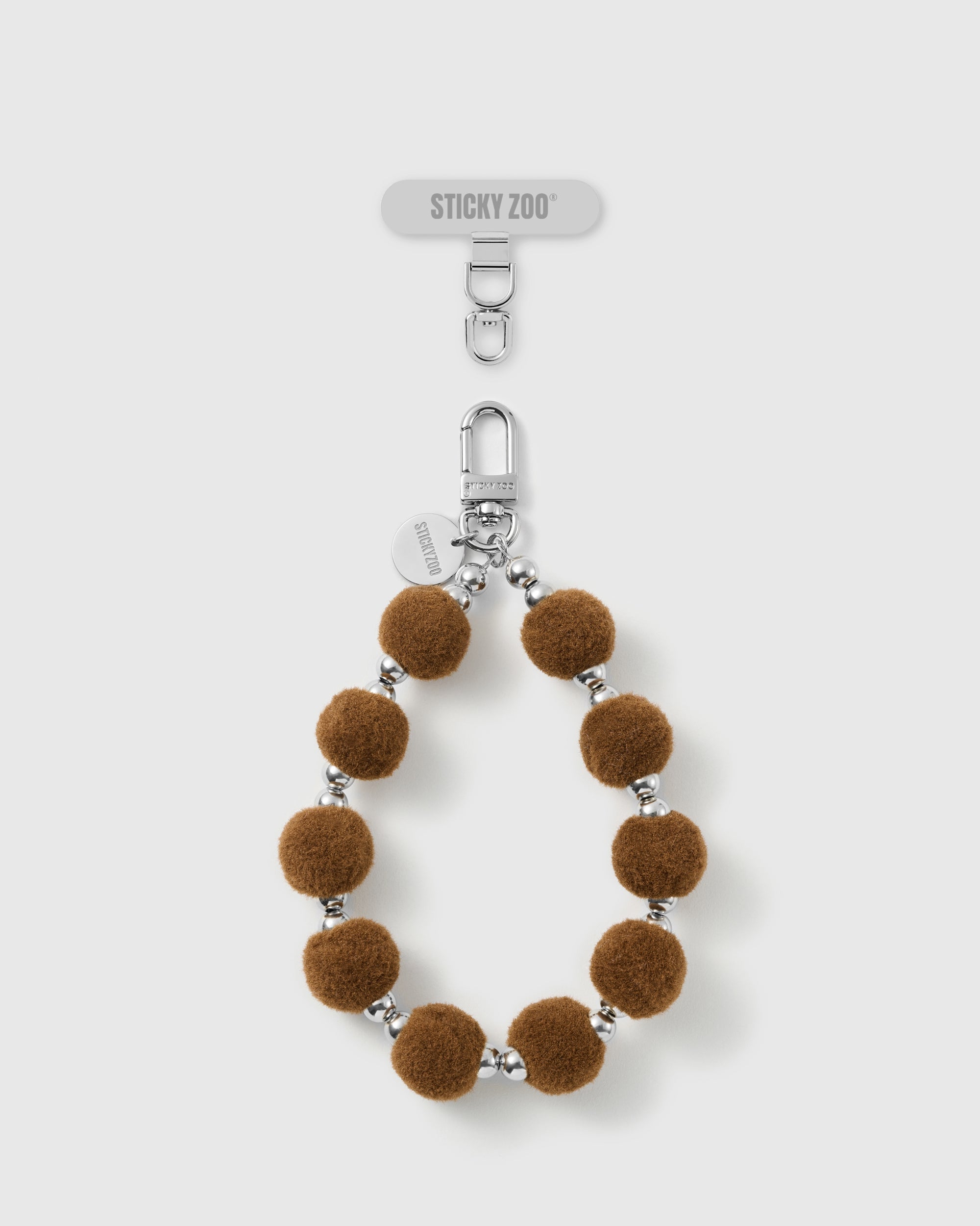 Handmade hazelnut velvet pom bead phone strap by STICKYZOO with silver-tone engraved hardware