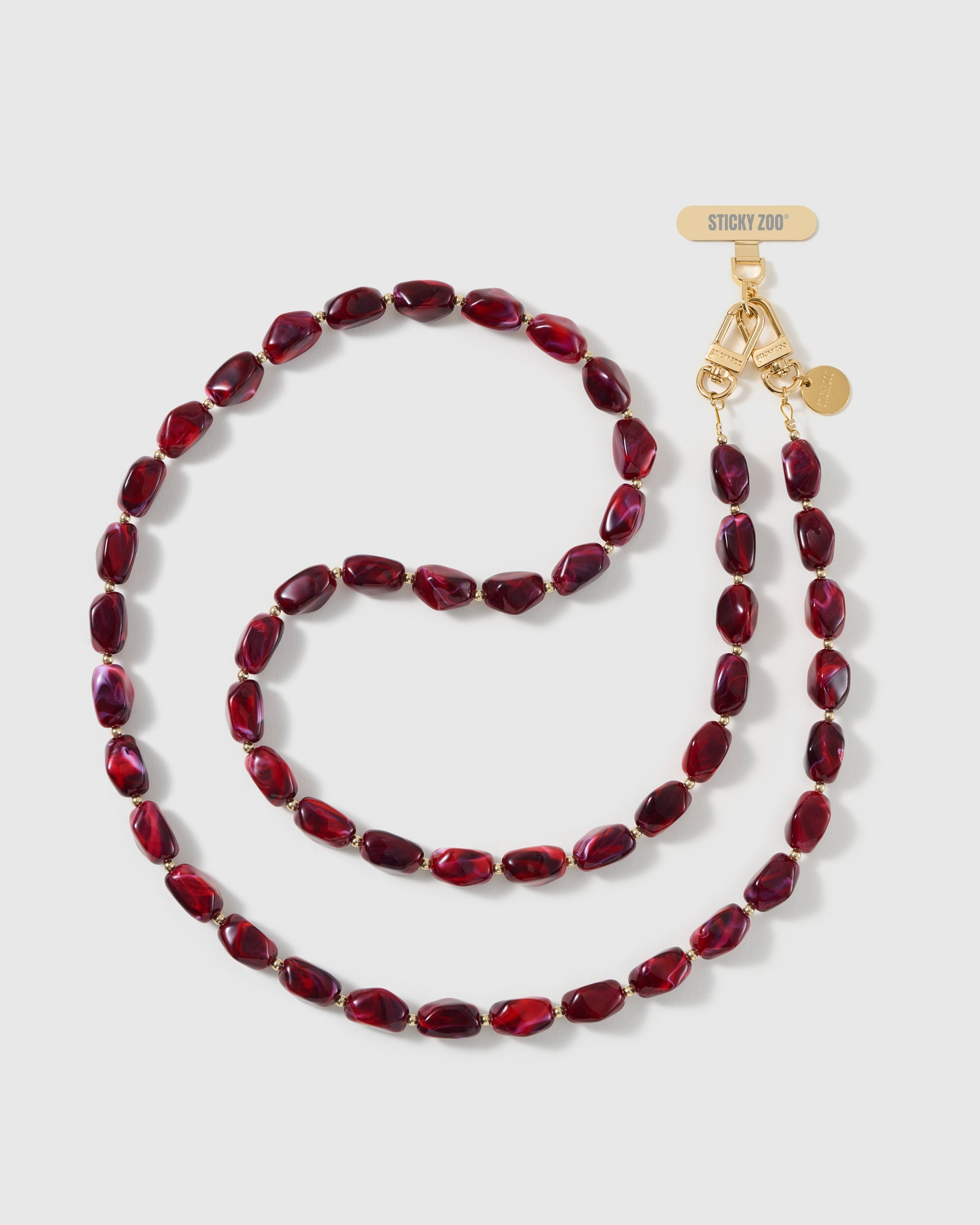 Full-length STICKYZOO cross-body phone strap strung with high-gloss deep-red resin nugget beads with a garnet swirl