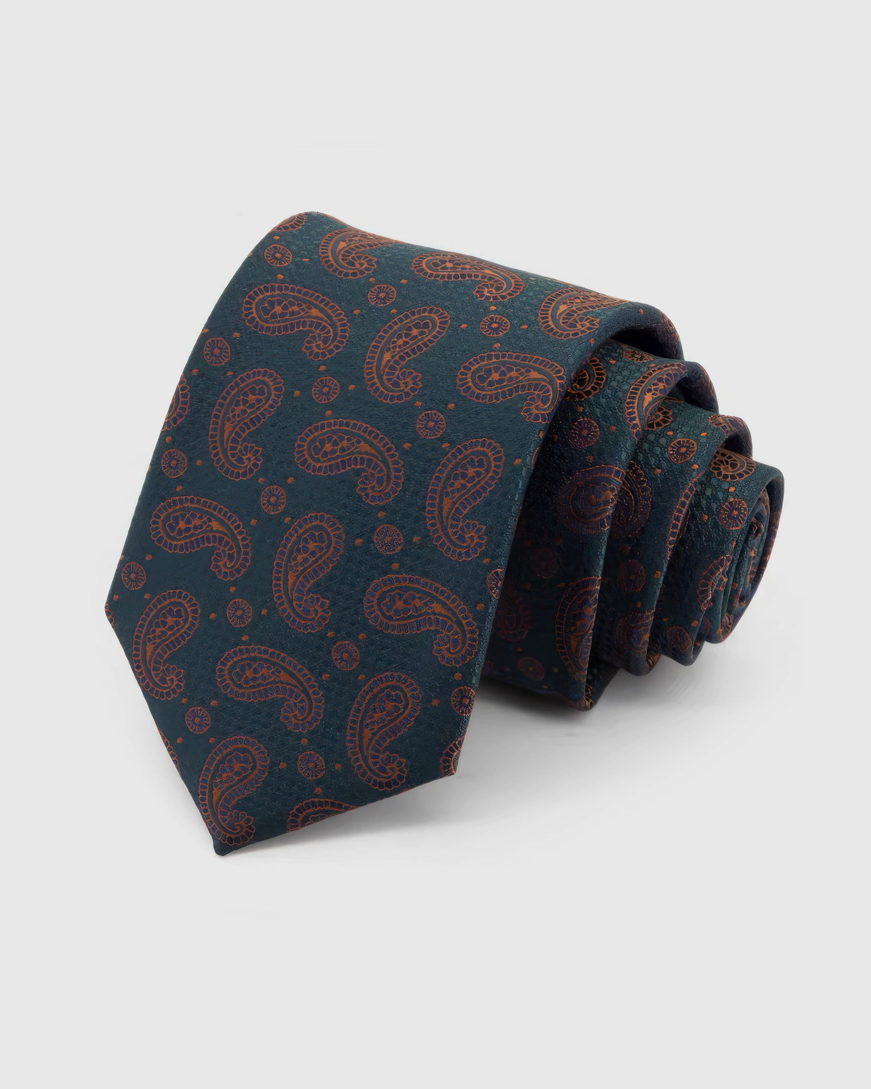 STICKYZOO Petrol Copper Paisley Tie rolled on white, showing a deep petrol ground covered in a fine copper-outline paisley repeat across the front blade.