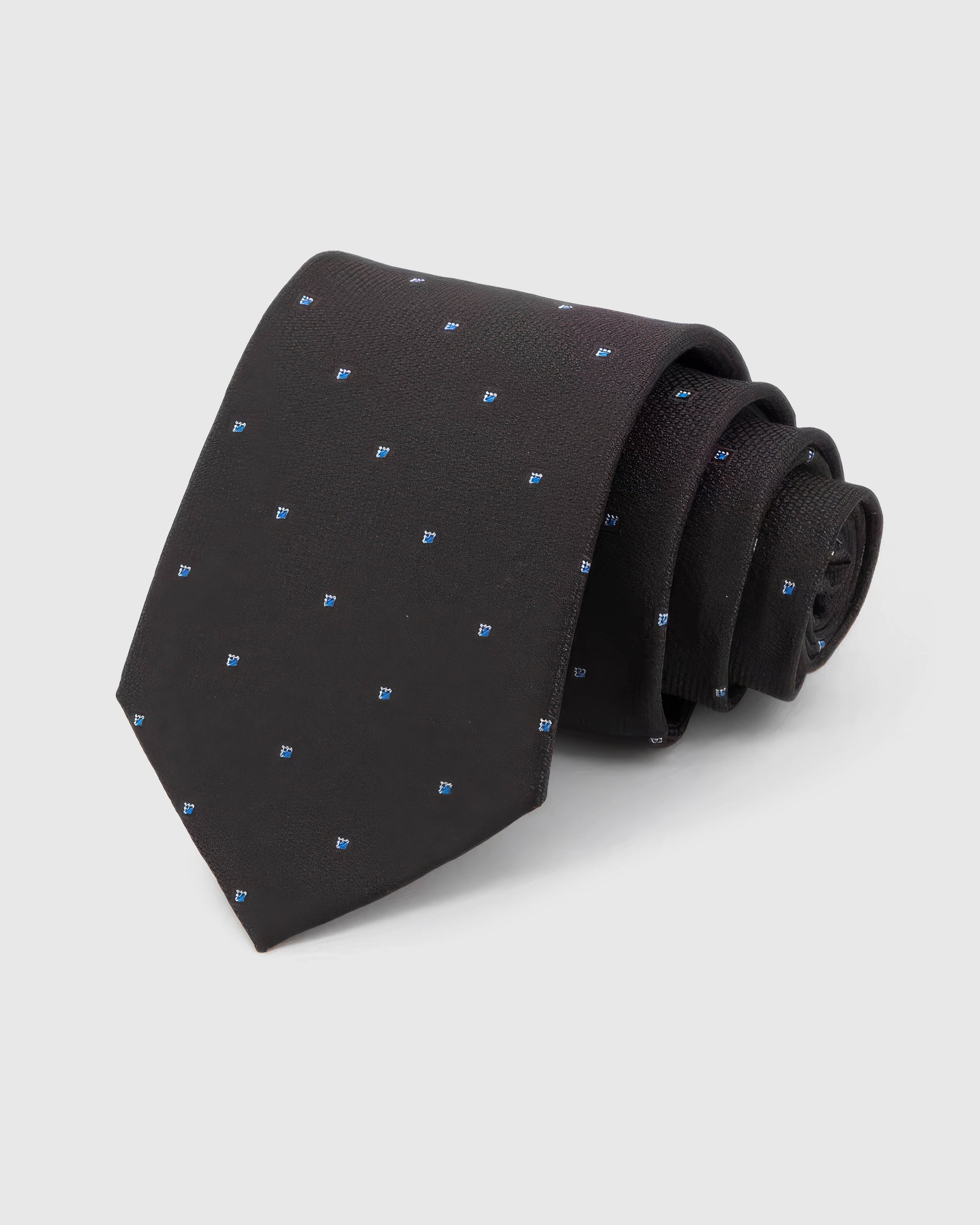 STICKYZOO Noir Blue Icon Tie in noir silk, rolled to show noir ground with small cobalt, azure and white abstract icons across the blade.