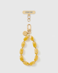 Handmade amber marbled bead phone strap by STICKYZOO with 18K gold-plated engraved hardware