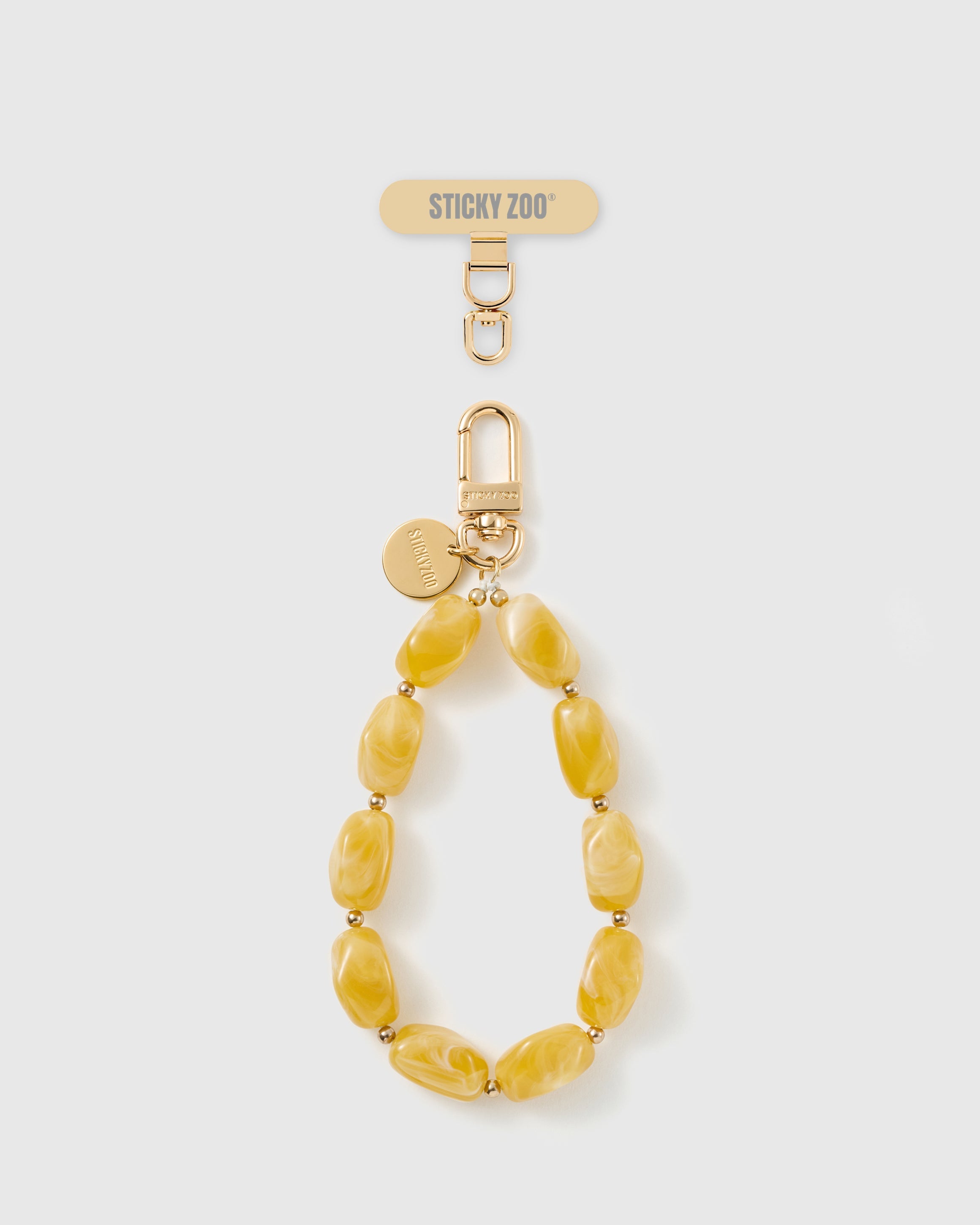Handmade amber marbled bead phone strap by STICKYZOO with 18K gold-plated engraved hardware