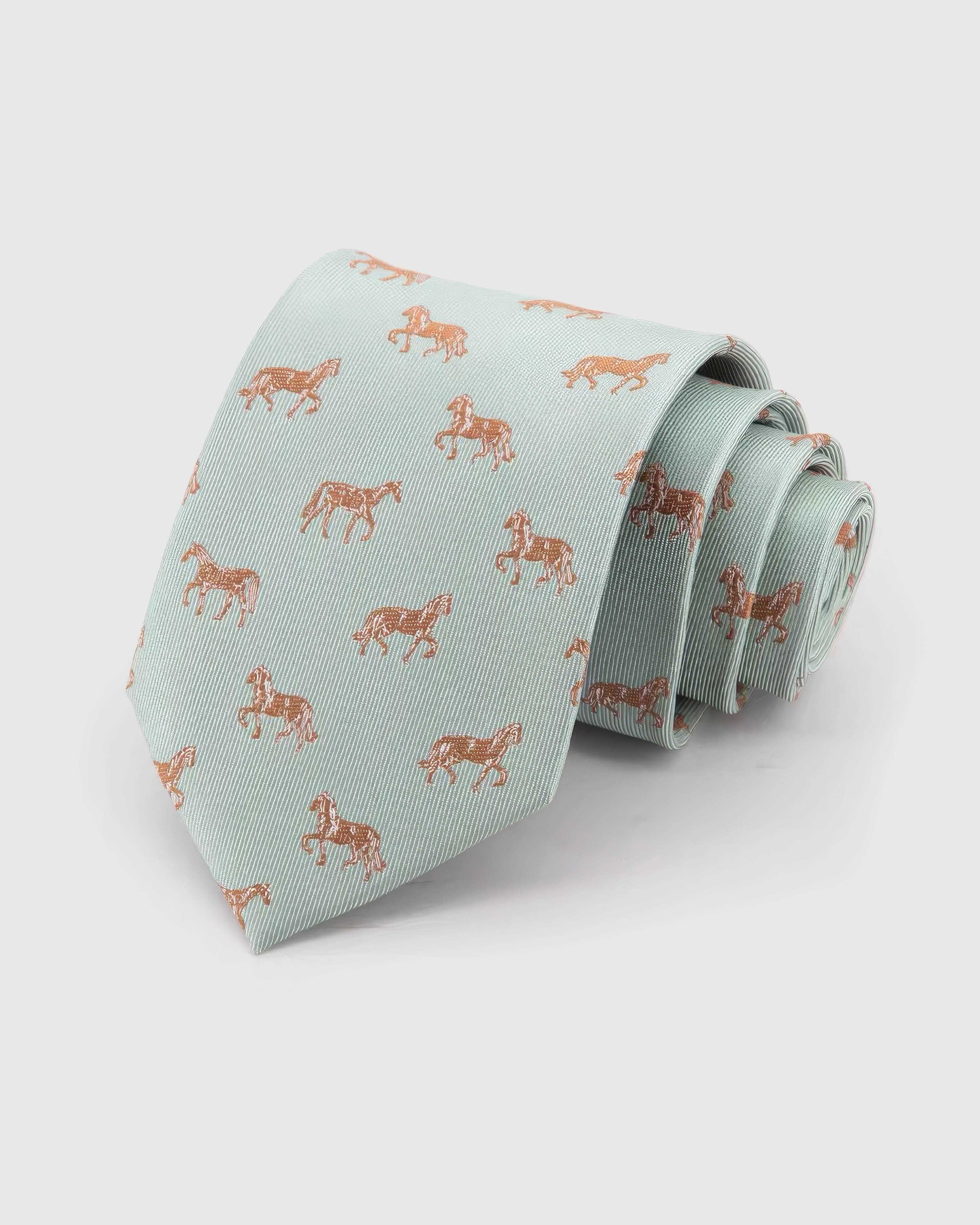 STICKYZOO Celadon Copper Horse Tie rolled on white, showing mixed copper horse illustrations across 100% mulberry silk in celadon mint