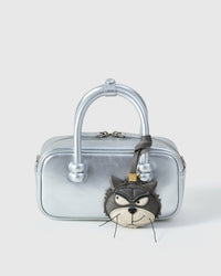 Grump cat charm styled on a metallic silver box bag, front — a small, specific piece that turns a simple bag into a statement.