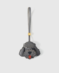 Handmade Poodle leather bag charm clipped to a leather handbag — French Alran goatskin, hand-cut and hand-stitched. STICKYZOO.