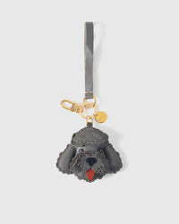 Handmade Poodle leather bag charm shown on a handbag — French Alran goatskin, 18K gold-plated hardware. STICKYZOO Amsterdam design.