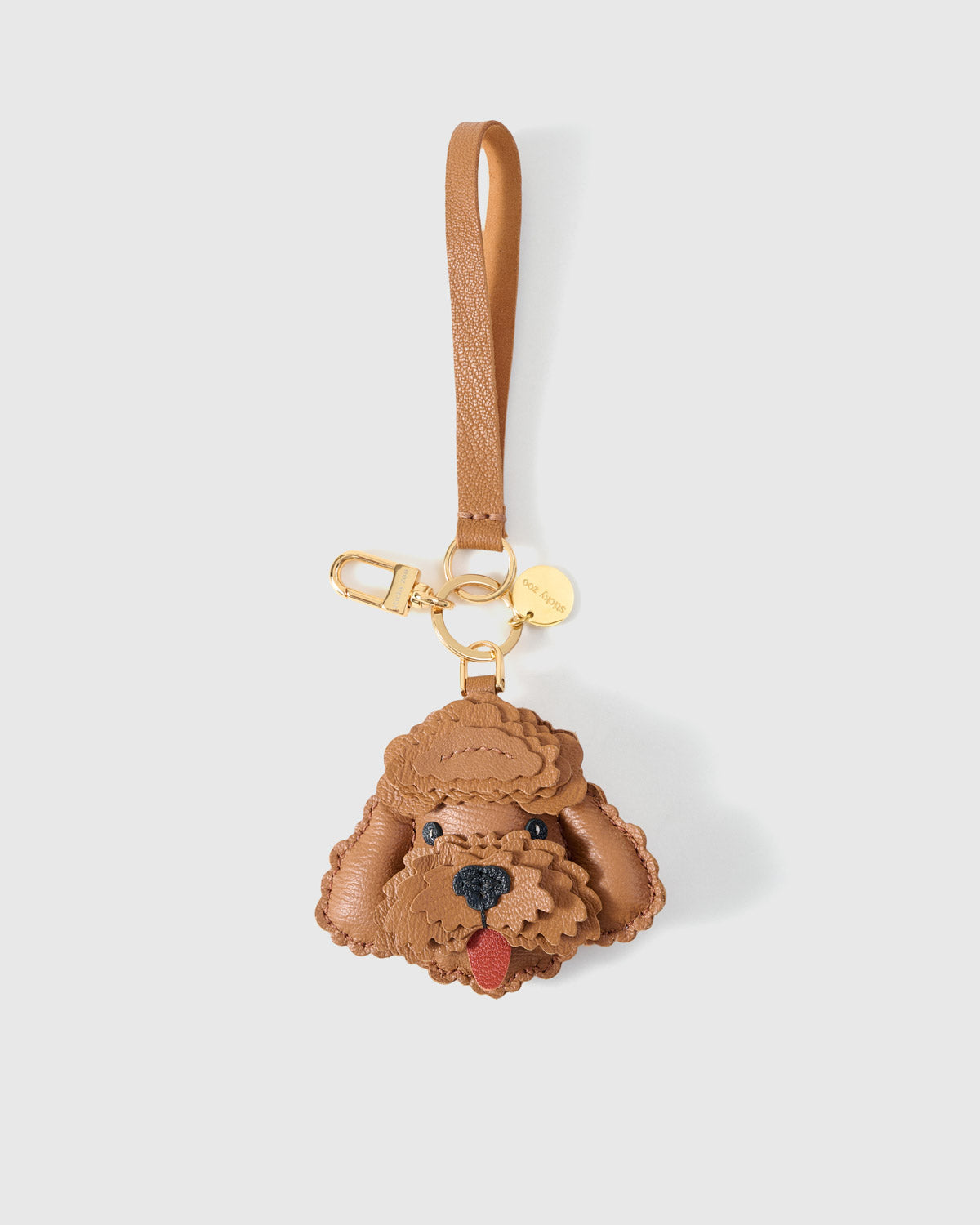 Close-up of handmade Poodle leather bag charm — hand-layered droopy ears in French Alran goatskin. STICKYZOO.