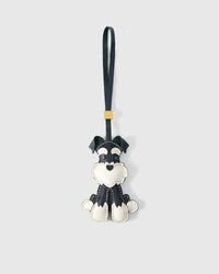 Black Urban Schnauzer charm handmade from French Alran genuine goatskin and French suede — real full-grain leather from Tarn, since 1903. 3 days of hand-cutting, hand-stitching, hand-layering. Arrives in luxury gift packaging. Designed in Amsterdam.