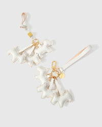 Wear the triple schnauzer charm on a bag with the leather strap loop, or clip it to keys with the 18K gold-plated keychain clip.