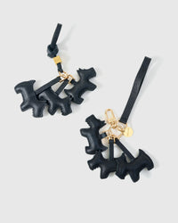 Wear the triple schnauzer charm on a bag with the leather strap loop, or clip it to keys with the 18K gold-plated keychain clip.