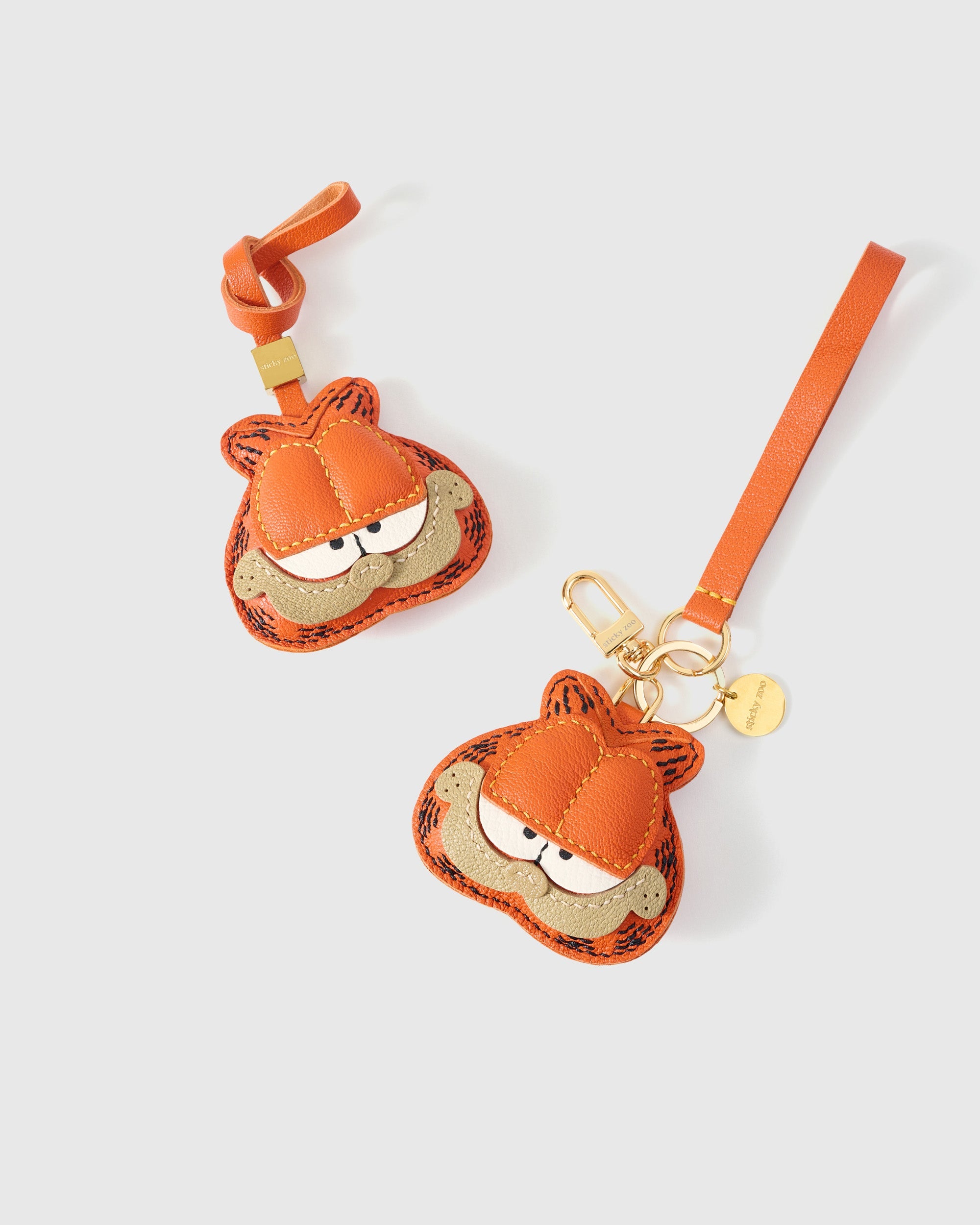 Garfield charm on a bag, side angle — 5,000+ reviews across STICKYZOO. Real French leather, 3 days by hand.