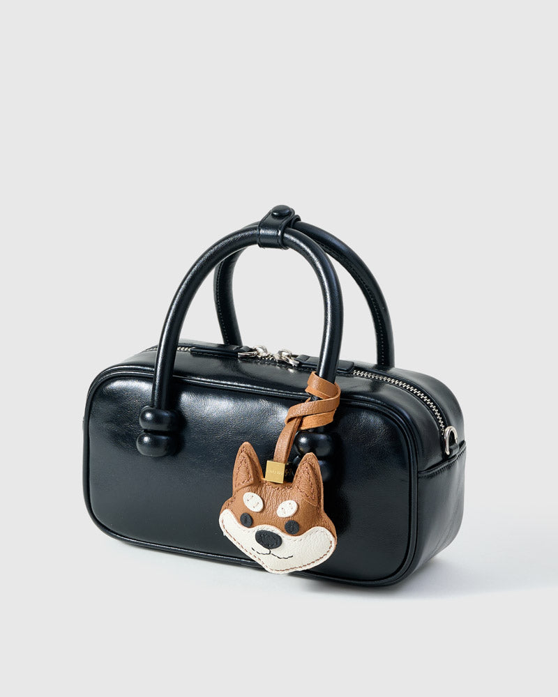 Wear the orange Tokyo Shiba charm on a bag with the leather strap loop, or clip it to keys with the 18K gold-plated keychain clip.