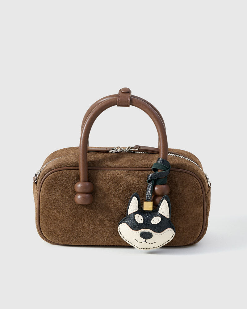 Every panel of the black Tokyo Shiba charm is cut by hand and stitched through real French leather. Layered slowly for depth — no prints, no stamps.