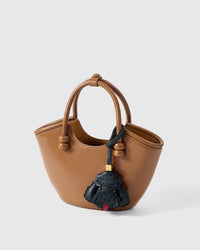 Poodle leather bag charm shown in both attachment options — handmade French Alran goatskin, dual attachment for bags or keys. STICKYZOO Amsterdam design.